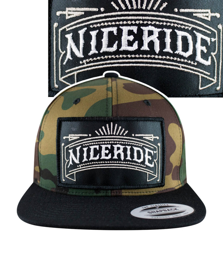 Cholo patch camo snapback hat featuring NICERIDE logo embroidered on the front and camo design.