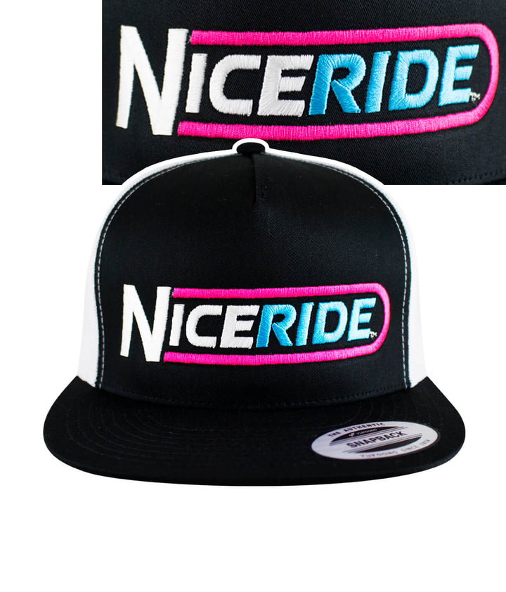 Black trucker hat featuring NICERIDE logo in bold pink and blue embroidery on the front panel.