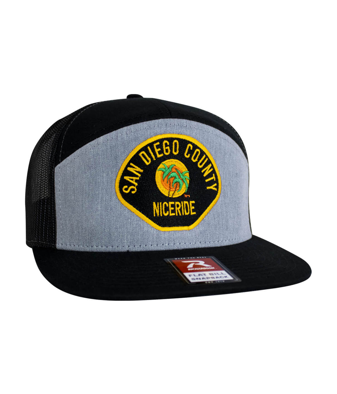 The Badge 7 Panel Trucker Hat featuring NICERIDE design and San Diego County embroidery.