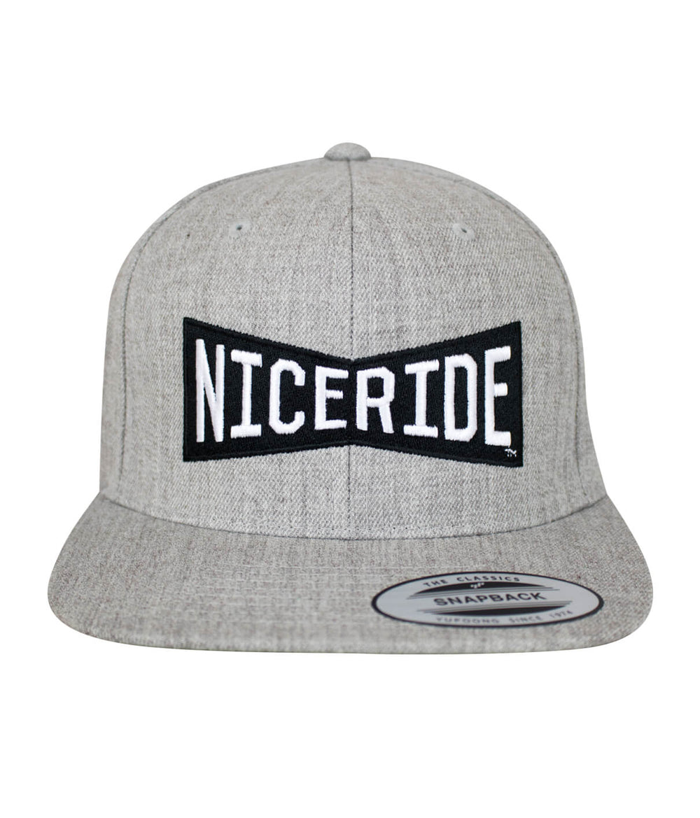 Bow Tie Snapback hat featuring NICERIDE logo embroidered on the front and side. Stylish and classic hat option.