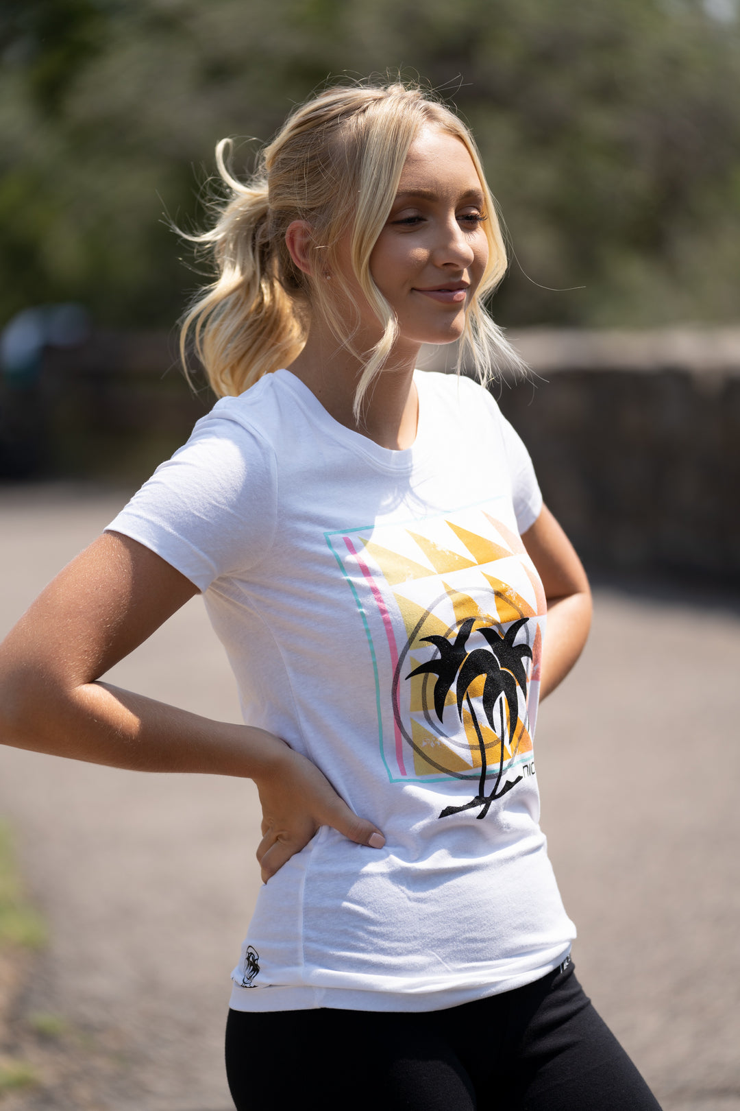 Valley Girl shirt featuring a palm tree design, model wearing a white crew neck t-shirt outdoors.