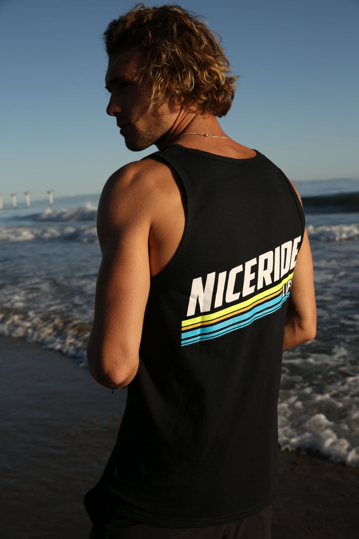 Man wearing a black tank top by Fruit Of The Loom with &