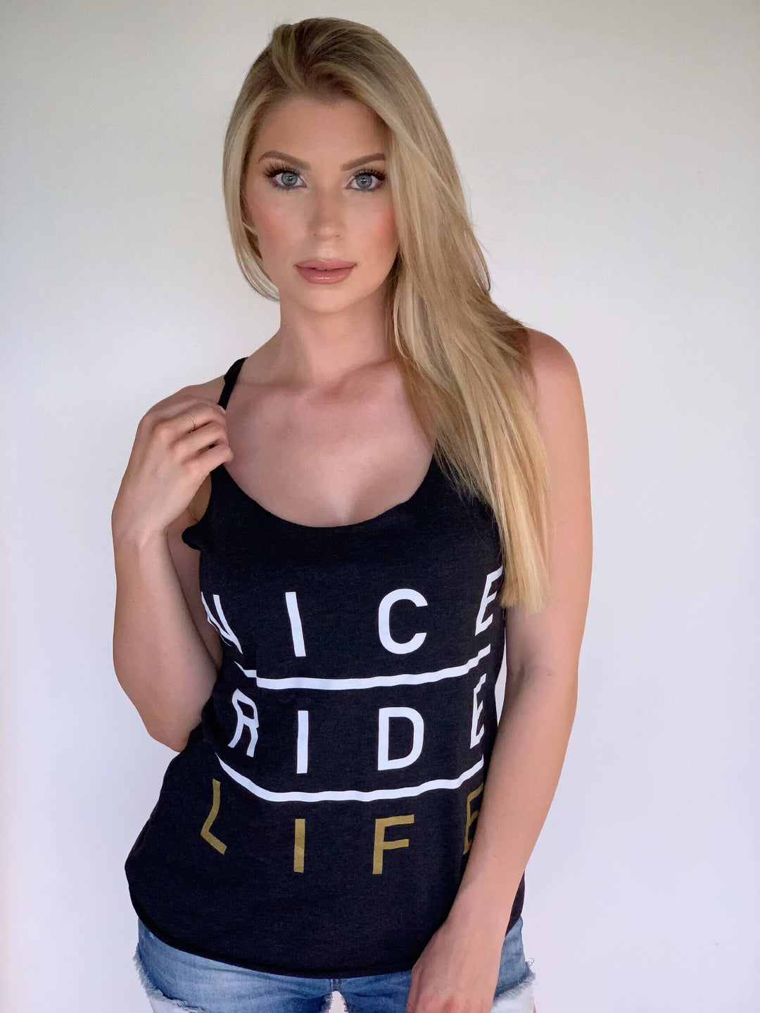 Model wearing a black tank top with &