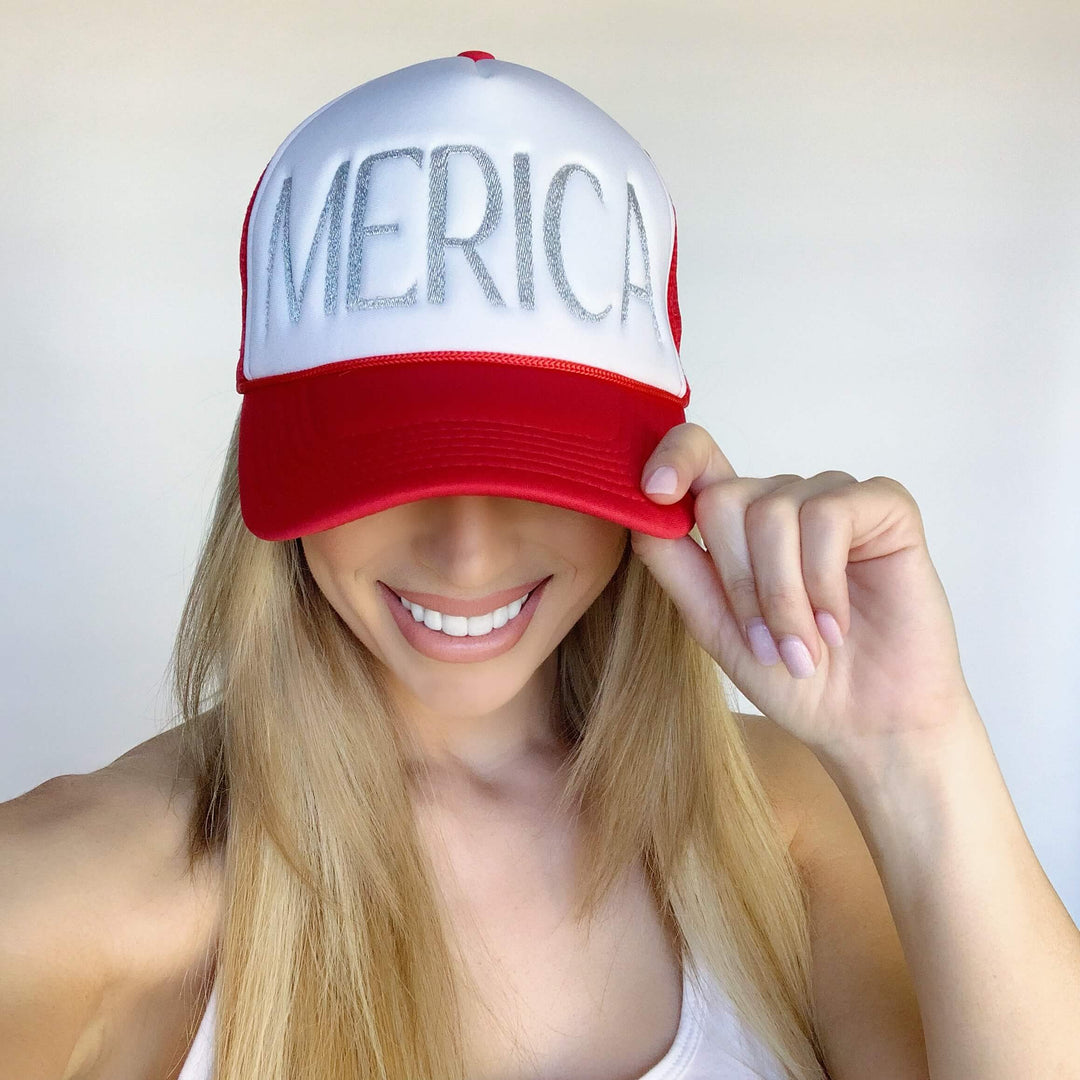 Woman wearing a "Merica" Foam Trucker hat with metallic silver thread embroidery. Perfect hat for casual outings.