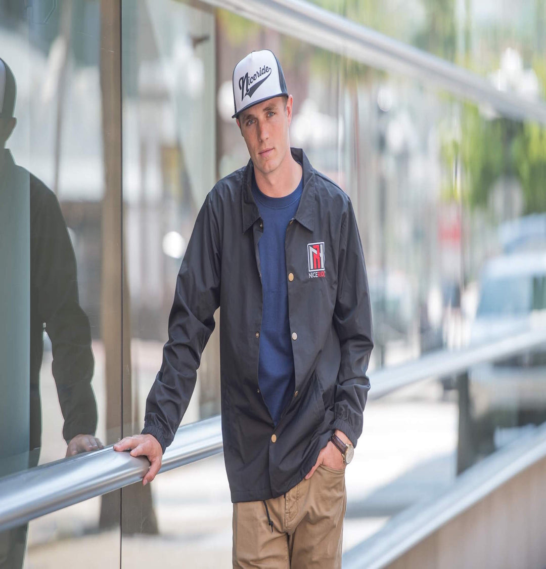 Model wearing N-R Windbreaker Jacket with NICERIDE logo, featuring waterproof coating and drawstring waist.