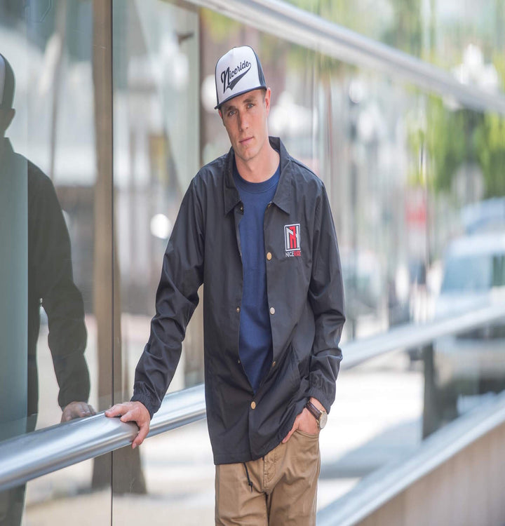 Model wearing N-R Windbreaker Jacket with NICERIDE logo, featuring waterproof coating and drawstring waist.