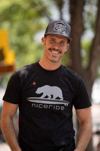 Smiling man wearing a black t-shirt with &