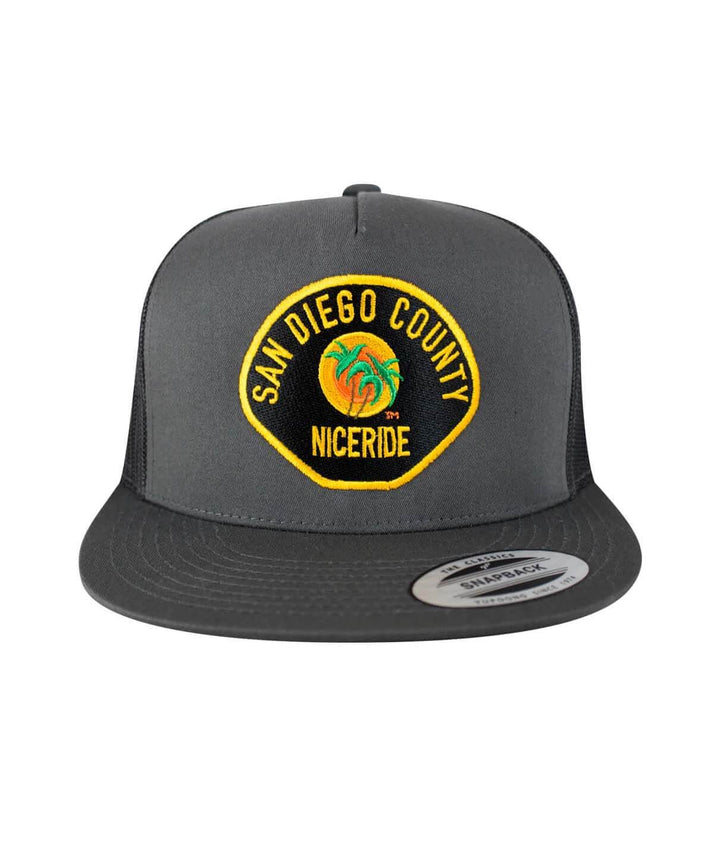 The Badge hat featuring San Diego County design with NICERIDE embroidery on a classic snapback trucker style.
