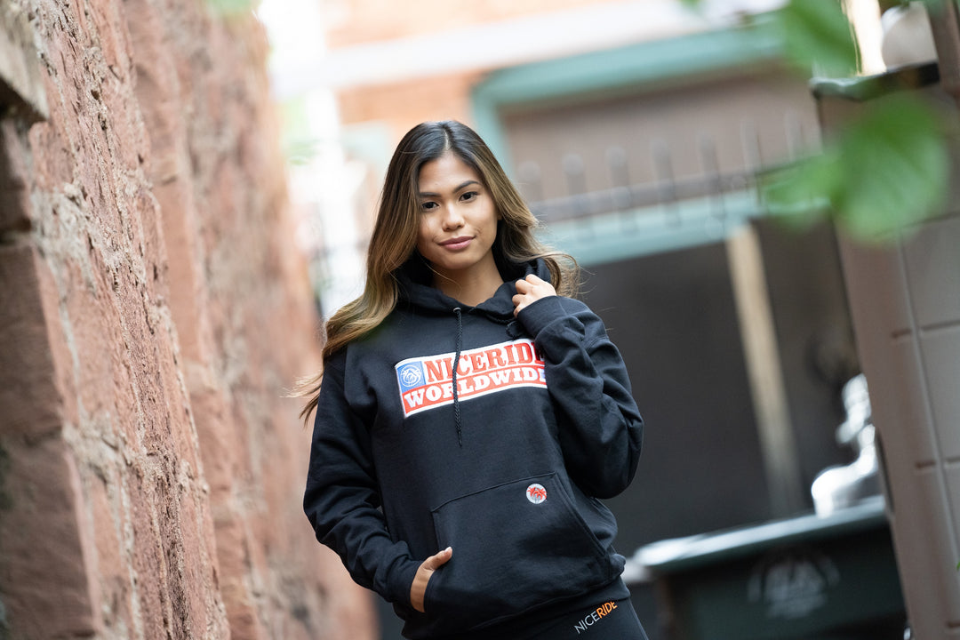 Nashville black pullover hoodie for men and women, featuring NICERIDE design, model wearing in urban setting.